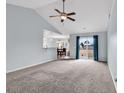 Bright living room with large windows, plush carpeting, and an open layout at 206 Balsa Dr., Longs, SC 29568