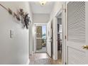 Inviting hallway with neutral walls, tiled floor, and a view of the screened porch through a glass door at 210 Portsmith Dr. # 2, Myrtle Beach, SC 29588