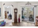 Cozy living room featuring hardwood floors, sliding glass doors to the sunroom, and an antique grandfather clock at 210 Portsmith Dr. # 2, Myrtle Beach, SC 29588