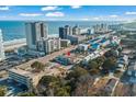 Aerial view of a coastal property featuring a community pool, nearby beach, and surrounding buildings at 2600 S Ocean Blvd. # 101, Myrtle Beach, SC 29577