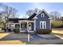 Beautiful blue home with a classic white porch and manicured lawn at 309 W Bond St., Marion, SC 29571