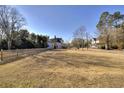 View of expansive yard, partially fenced with mature trees at 309 W Bond St., Marion, SC 29571
