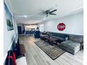 Bright, open living room with hardwood floors and view into the kitchen at 330 Kiskadee Loop # A, Conway, SC 29526