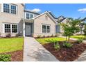 Well-maintained townhome with a sidewalk leading to the front door, surrounded by green grass and tasteful landscaping at 344 Kiskadee Loop # B, Conway, SC 29526