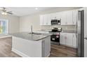 Kitchen with large island, stainless appliances, granite countertop, and hardwood style flooring at 344 Kiskadee Loop # F, Conway, SC 29526