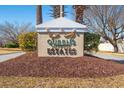 Elegant 'Queens Harbour Estates' sign, surrounded by lush greenery, welcomes residents and visitors at 3516 Queens Harbour Blvd., Myrtle Beach, SC 29588