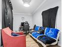 Cozy bedroom with a black gaming chair and a blue sofa featuring a controller pattern at 3530 Reavis Ln., Myrtle Beach, SC 29579