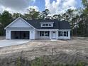 Inviting one-story house with a two-car garage and classic architectural details at 4020 Copperhead Rd., Conway, SC 29527