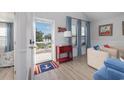 Bright living room with charming nautical decor, blue accents, and an inviting view from the open doorway at 409 36Th Ave. N, North Myrtle Beach, SC 29582