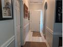 Well-lit hallway with neutral paint, white trim, and tiled floors offers a clean and inviting entry at 4221 Hibiscus Dr. # 101, Little River, SC 29566