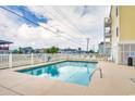 Community pool with clear blue water, surrounded by lounge chairs for relaxing poolside at 4601 N Ocean Blvd. # 201, North Myrtle Beach, SC 29582