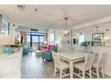 Open-concept living and dining area with stylish decor, balcony access, and ocean views at 4800 S Ocean Blvd. # 304, North Myrtle Beach, SC 29582