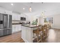 Bright, modern kitchen featuring white cabinets, stainless steel appliances, granite countertops, and a central island at 5026 Adrian Hwy., Conway, SC 29526