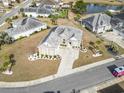 Aerial view of home in a quiet neighborhood near a pond with landscaped yard at 654 Evers Loop, Surfside Beach, SC 29575