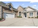 Close-up of a brick home featuring an attached garage and detailed front entrance at 654 Evers Loop, Surfside Beach, SC 29575
