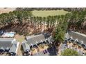 Aerial view of townhouses featuring ample parking, mature trees and golf course at 850 Fairway Dr. # 1003Ee, Longs, SC 29568