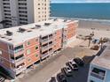 Aerial view of condo complex near the beach with parking and other amenities at 900 N Waccamaw Dr. # 203, Garden City Beach, SC 29576