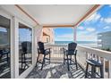 Balcony with seating overlooking the beach at 900 N Waccamaw Dr. # 203, Garden City Beach, SC 29576