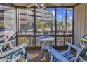 Relaxing screened-in balcony with comfortable seating, perfect for enjoying the outdoors at 9501 Shore Dr. # D-132, Myrtle Beach, SC 29572