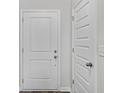 A bright hallway shows a white front door, with a second door and neutral walls at 108 Saddle St, Conway, SC 29527
