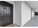 Condo front door number 305 with secure lock located along a corridor with clean white walls at 1210 N Waccamaw Dr. # 305, Murrells Inlet, SC 29576