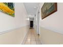 Hallway featuring neutral colors, tile floors, and artwork on the walls at 1210 N Waccamaw Dr. # 305, Murrells Inlet, SC 29576