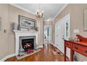 Inviting foyer with fireplace, chandelier, and wood floors at 1519 N Palmetto Dr., Surfside Beach, SC 29575