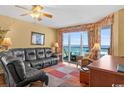 Relax in this cozy living room with ocean views from floor-to-ceiling windows at 1706 S Ocean Blvd. # 1001, North Myrtle Beach, SC 29582