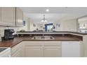 Kitchen with stainless sink with a breakfast bar overlooking the living area at 201 74Th Ave. N # 703, Myrtle Beach, SC 29572