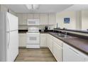 A well-maintained kitchen features essential appliances and ample counter space at 201 74Th Ave. N # 703, Myrtle Beach, SC 29572