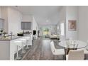 Bright living room with modern decor, featuring wood floors, stylish furniture, and lots of natural light at 205 Kinross Ct., Little River, SC 29566