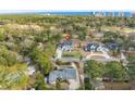 Wide aerial perspective of a home nestled among trees near a golf course with a view of the coastline at 208 Green Lake Dr., Myrtle Beach, SC 29572