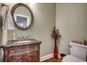 Half bathroom with a decorative vanity, mirror, and a vase with flowers at 232 Wahee Pl., Conway, SC 29527