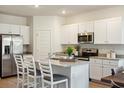 Modern kitchen with white cabinets, granite countertops, stainless steel appliances, and a kitchen island at 316 Brackish Dr. # 316, Myrtle Beach, SC 29588