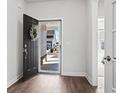 Inviting entryway with dark wood flooring, open door with wreath and view to the outside at 3215 Preciado Dr., Myrtle Beach, SC 29579