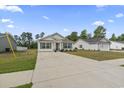 Wide view of the home exterior featuring a long driveway, manicured lawn, and inviting curb appeal at 3500 Church St., Loris, SC 29569
