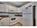 Bright kitchen featuring white appliances, cabinets, and dark countertops at 3555 Highway 544 # 4-C, Conway, SC 29526