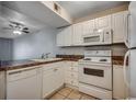 Well-lit kitchen features white cabinets, appliances, and tiled flooring at 3555 Highway 544 # 4-C, Conway, SC 29526
