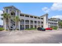 Condo exterior with balconies, landscaping, and parking in front of the building at 4503 W Harbour Ct. # S-6, Little River, SC 29566