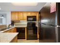 Well-equipped kitchen features wood cabinets, granite countertops, and modern appliances at 4800 S Ocean Blvd. # 204, North Myrtle Beach, SC 29582