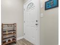 Bright entryway featuring a white door, decorative wall art, and a wooden shelf for storage at 500 Willow Greens Dr. # 500-G, Conway, SC 29526