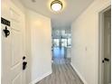 Bright entryway features luxury vinyl plank flooring leading into a modern, freshly painted living space at 5000 Windsor Green Way # 204, Myrtle Beach, SC 29579
