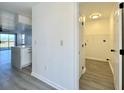 Hallway with view of luxury vinyl plank flooring and bright, newly painted walls and updated lighting at 5000 Windsor Green Way # 204, Myrtle Beach, SC 29579