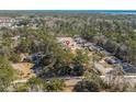 An aerial view showing the property's location within a wooded neighborhood close to the ocean at 55 Porch Ln., Pawleys Island, SC 29585