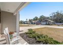 Inviting porch view showcasing landscaped garden beds and a cozy seating area at 55 Porch Ln., Pawleys Island, SC 29585