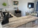 Bright kitchen featuring granite counters, stainless steel microwave and eat-in dining at 6000 N Ocean Blvd. # 122, North Myrtle Beach, SC 29582