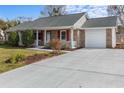 Traditional brick home with an attached garage and a well-maintained driveway at 614 Cavandish Dr., Myrtle Beach, SC 29588