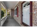 Close-up of a white front door with brick facade and covered porch at 614 Cavandish Dr., Myrtle Beach, SC 29588