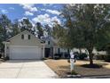 Inviting home exterior featuring a well-manicured lawn and a charming mailbox at 7471 Balmore Dr. Sw, Sunset Beach, NC 28468
