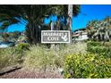 Sign for Mariner's Cove with seagull and pelican graphics amidst lush landscaping and blue skies at 9501 Shore Dr. # D-337, Myrtle Beach, SC 29572